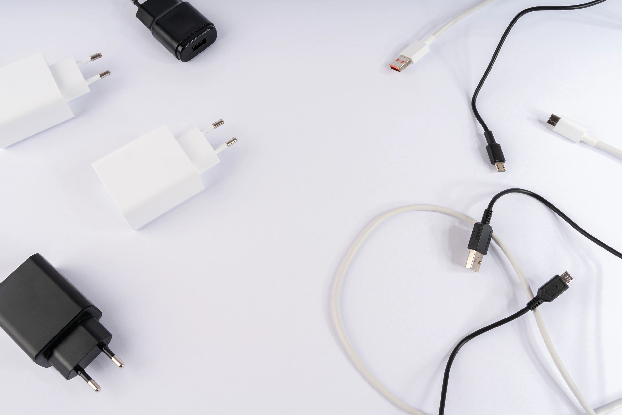 USB wall chargers and USB-C cables arranged on a white background
